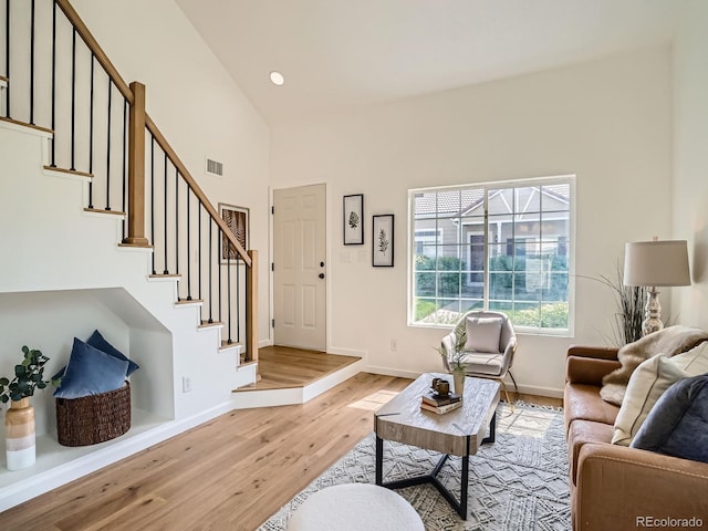21472 E 46th Ave, Denver, CO 80249 - living room with light wood-style flooring, stairs, high vaulted ceiling, baseboards, and recessed lighting