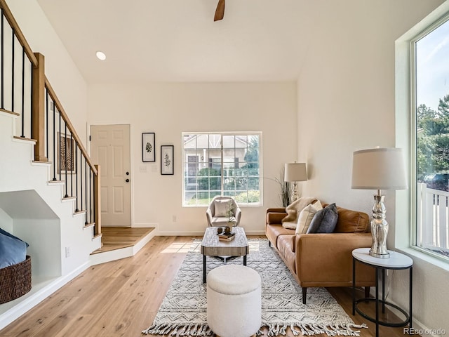 21472 E 46th Ave, Denver, CO 80249 - living room with light wood-style floors, stairs, baseboards, a ceiling fan, and recessed lighting