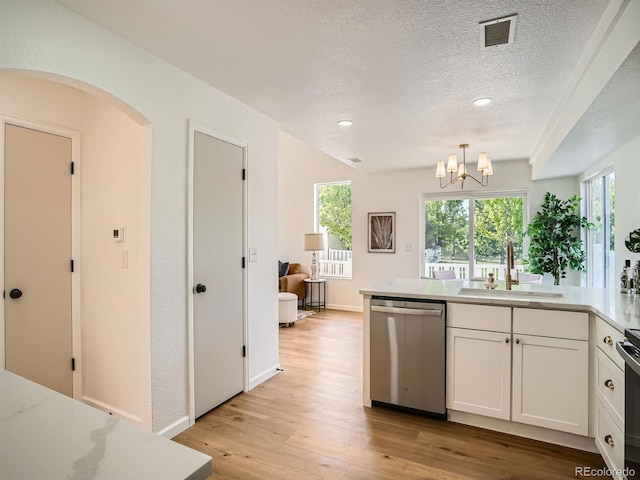 21472 E 46th Ave, Denver, CO 80249 - kitchen featuring stainless steel dishwasher, a sink, white cabinetry, light wood-style floors, and a chandelier
