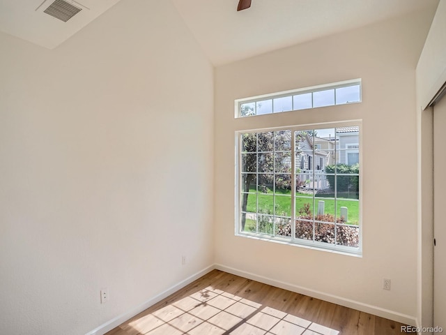 21472 E 46th Ave, Denver, CO 80249 - empty room with light wood finished floors, baseboards, high vaulted ceiling, and a ceiling fan
