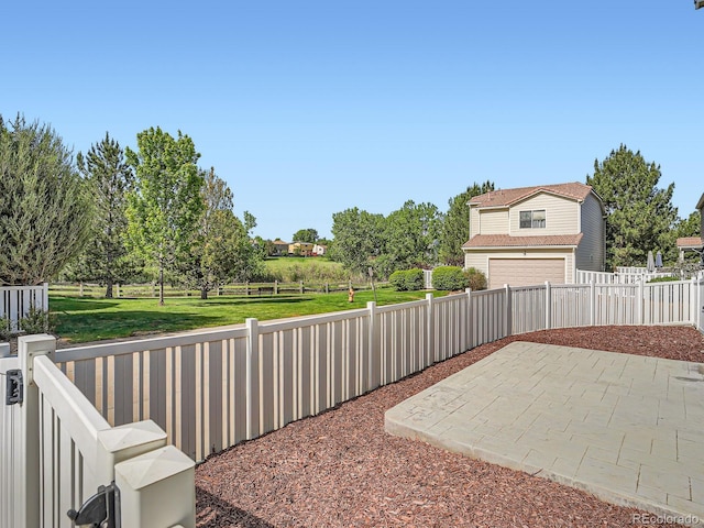 21472 E 46th Ave, Denver, CO 80249 - view of patio featuring a garage and driveway