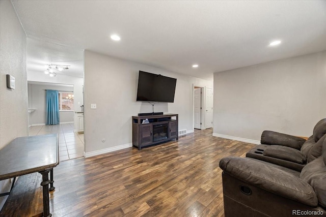 2121 Carmel Dr, Colorado Springs, CO 80910 - living area with wood finished floors, baseboards, and recessed lighting