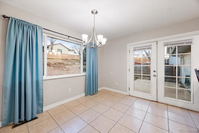 2121 Carmel Dr, Colorado Springs, CO 80910 - unfurnished dining area featuring french doors, a healthy amount of sunlight, tile patterned flooring, and a chandelier