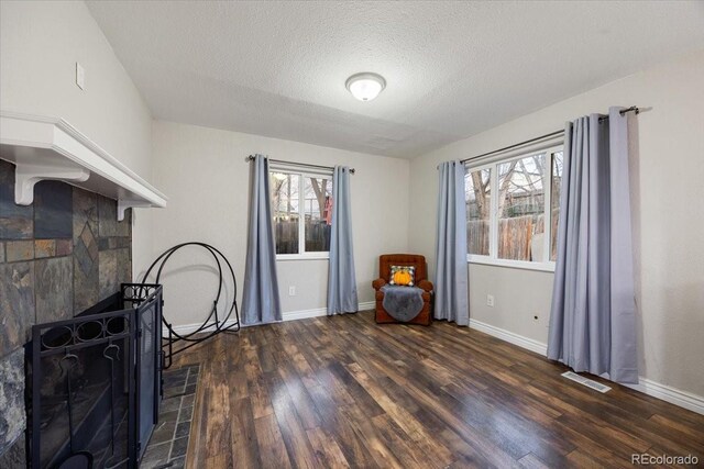 2121 Carmel Dr, Colorado Springs, CO 80910 - living area featuring visible vents, baseboards, plenty of natural light, and wood finished floors