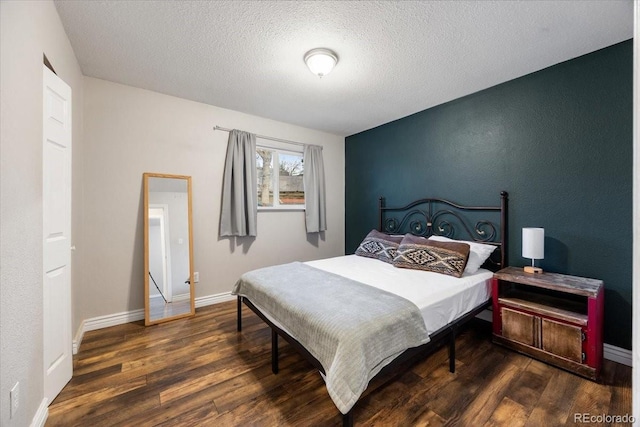 2121 Carmel Dr, Colorado Springs, CO 80910 - bedroom with a textured ceiling, wood finished floors, and baseboards