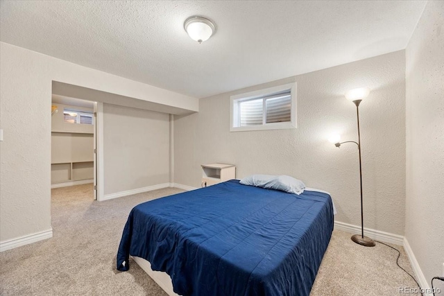 2121 Carmel Dr, Colorado Springs, CO 80910 - carpeted bedroom with baseboards, a textured wall, and a textured ceiling