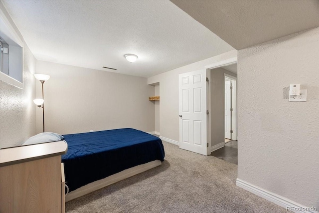 2121 Carmel Dr, Colorado Springs, CO 80910 - bedroom featuring a textured ceiling, visible vents, carpet flooring, a textured wall, and baseboards