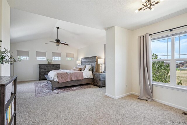 carpeted bedroom featuring baseboards, a ceiling fan, visible vents, and vaulted ceiling