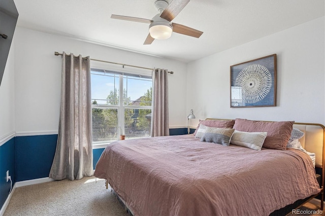 bedroom featuring baseboards, ceiling fan, and carpet