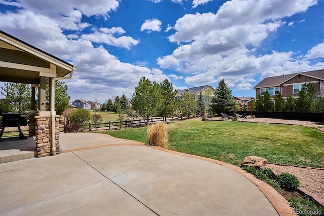 surrounding community featuring a lawn, fence, a residential view, and a patio