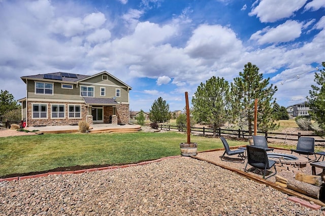 view of yard featuring fence, a fire pit, and a patio area