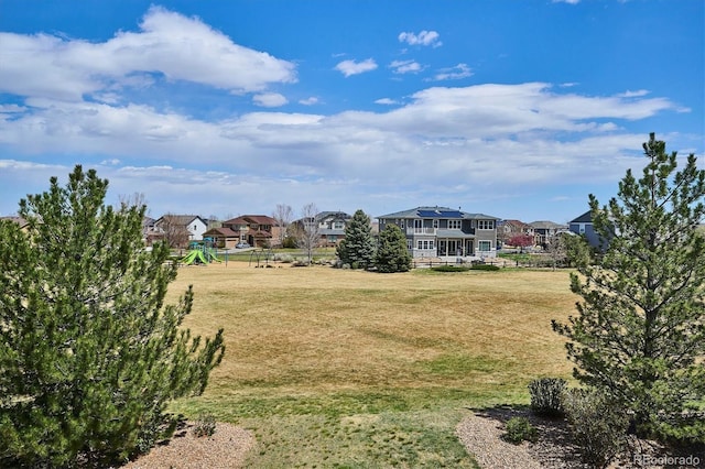 view of yard featuring playground community and a residential view