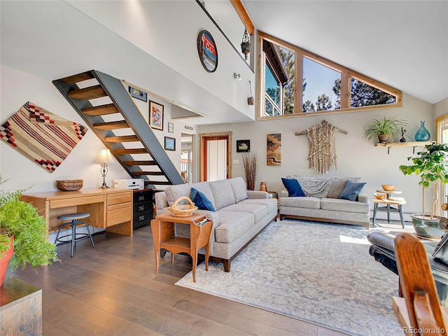 living room featuring stairway, a baseboard radiator, high vaulted ceiling, and dark wood-style flooring