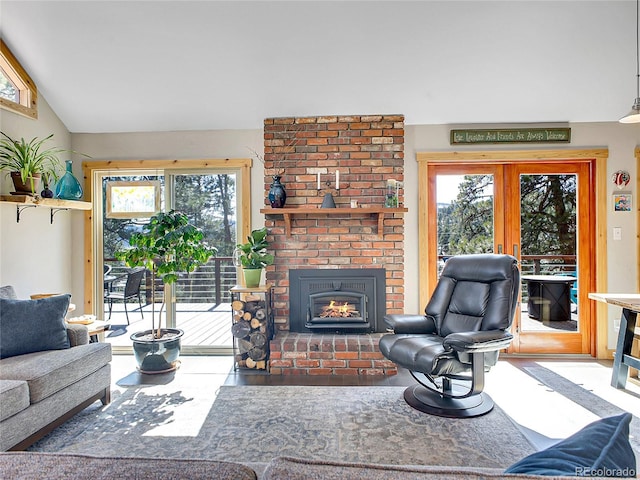 living area with lofted ceiling, a brick fireplace, wood finished floors, and french doors