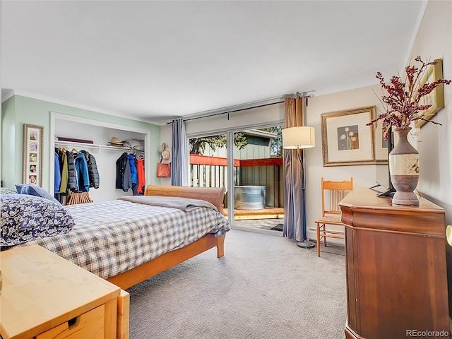 carpeted bedroom featuring access to exterior, crown molding, a closet, and a baseboard radiator