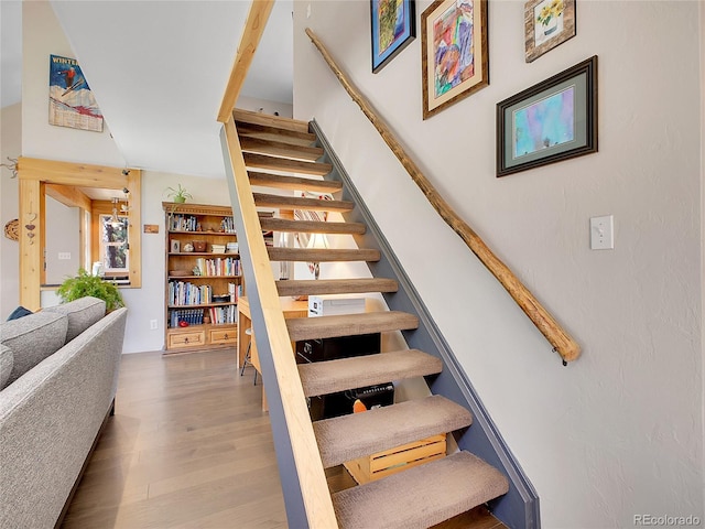 stairway with wood finished floors