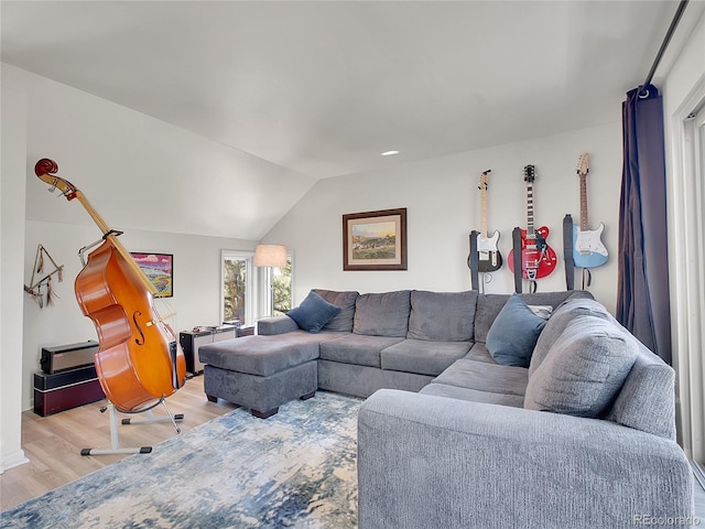 living area with lofted ceiling and light wood-style floors