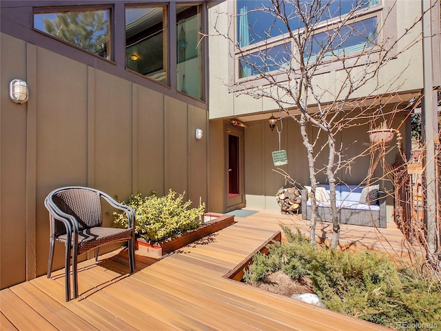 exterior space with a wooden deck and board and batten siding