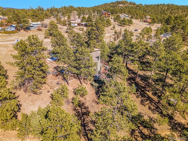 birds eye view of property with a view of trees