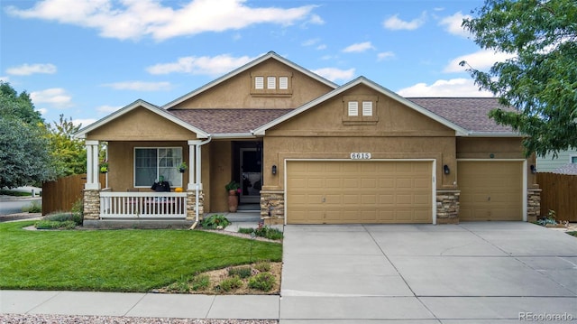 6615 Annanhill Pl, Colorado Springs, CO 80922 - view of front facade featuring covered porch, stone siding, an attached garage, stucco siding, and driveway