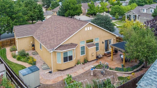 6615 Annanhill Pl, Colorado Springs, CO 80922 - back of house with stucco siding, a fenced backyard, a patio area, and a shed