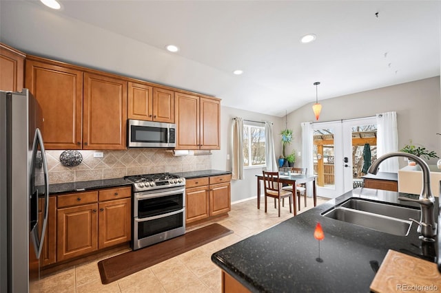 6615 Annanhill Pl, Colorado Springs, CO 80922 - kitchen featuring stainless steel appliances, french doors, tasteful backsplash, recessed lighting, and brown cabinetry