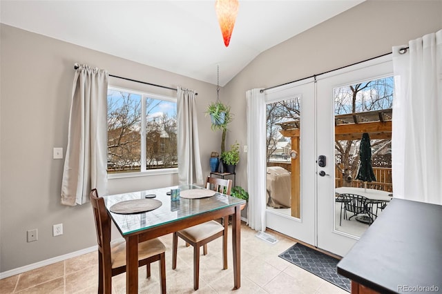 6615 Annanhill Pl, Colorado Springs, CO 80922 - dining space with lofted ceiling, plenty of natural light, light tile patterned floors, and french doors