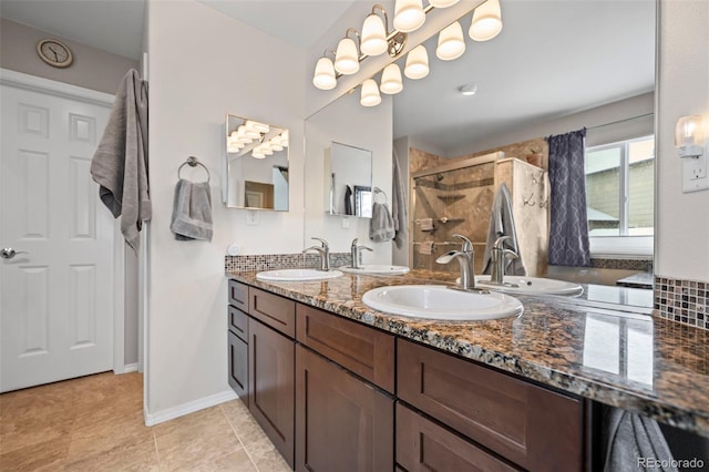 6615 Annanhill Pl, Colorado Springs, CO 80922 - full bath featuring double vanity, a shower stall, and tile patterned floors
