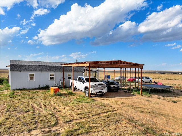 view of vehicle parking featuring a carport