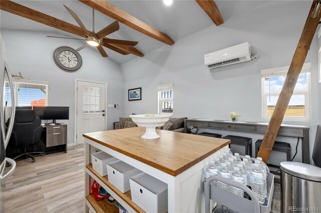 interior space with beam ceiling, butcher block counters, light wood-style floors, an AC wall unit, and high vaulted ceiling