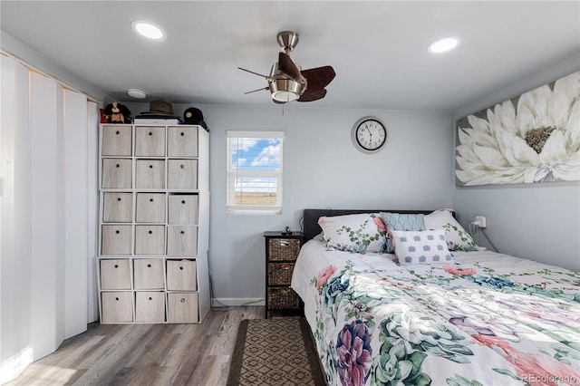 bedroom with ceiling fan, wood finished floors, and recessed lighting