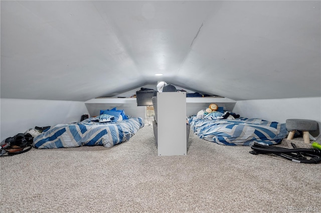 bedroom with carpet and vaulted ceiling