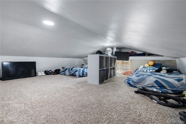 bedroom with carpet floors and vaulted ceiling