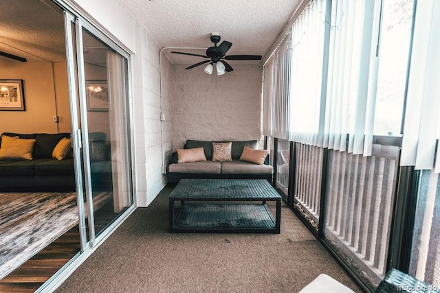 sunroom / solarium featuring ceiling fan