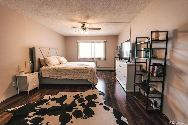 bedroom with dark wood-type flooring, a baseboard radiator, a textured ceiling, and a ceiling fan