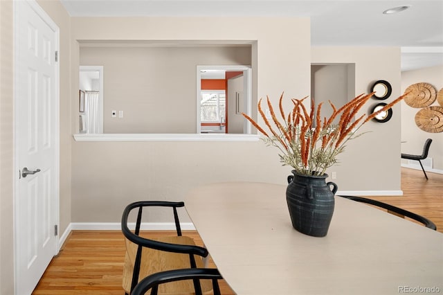 interior space featuring baseboards and wood finished floors