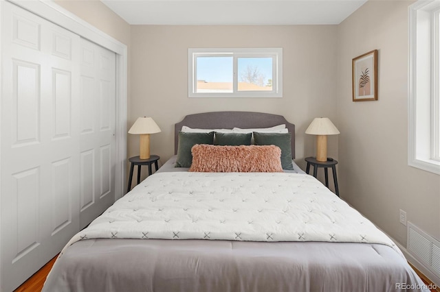 bedroom featuring visible vents and a closet