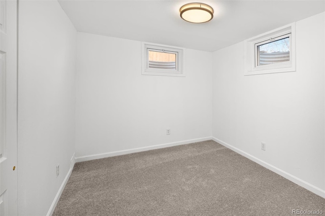 carpeted spare room with baseboards