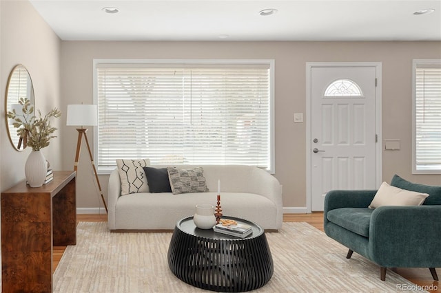 living area with recessed lighting, baseboards, and light wood finished floors