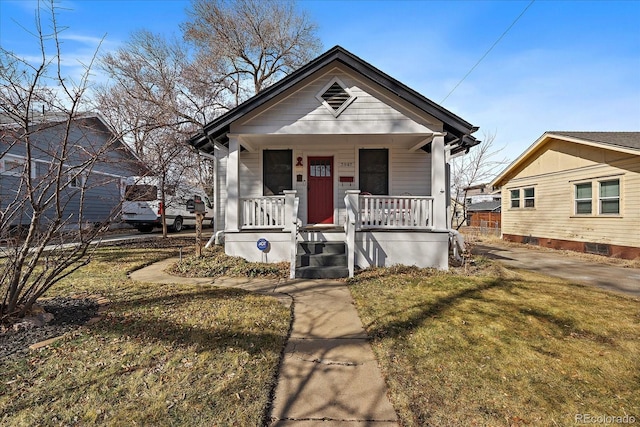 view of front of property with a porch and a front lawn