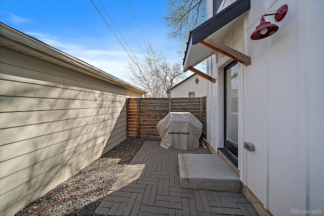 view of patio featuring grilling area and fence
