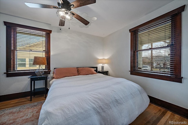 bedroom with baseboards, a ceiling fan, and wood finished floors