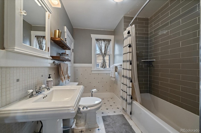 bathroom featuring shower / bath combo, wainscoting, tile walls, toilet, and tile patterned flooring