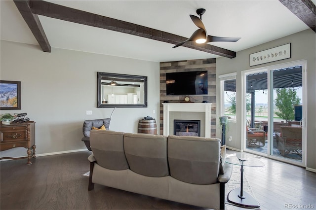 living area featuring a fireplace, wood finished floors, beam ceiling, and baseboards