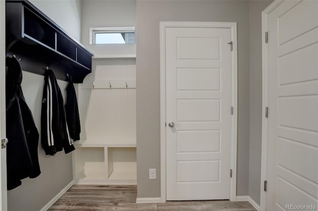 mudroom featuring baseboards and wood finished floors