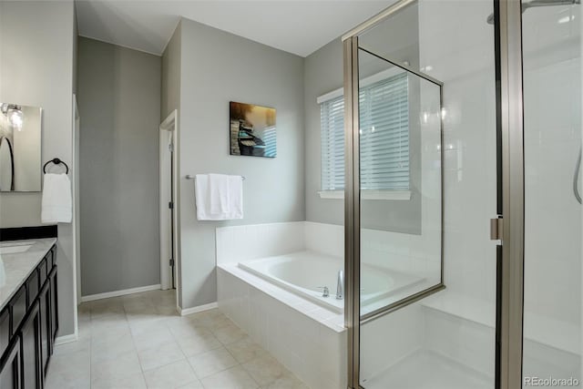 full bathroom with baseboards, tile patterned flooring, vanity, a shower stall, and a bath