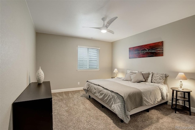 carpeted bedroom with ceiling fan and baseboards