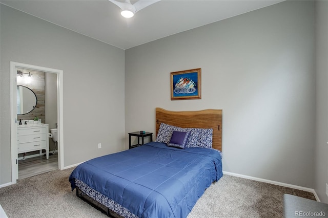 bedroom with baseboards, carpet flooring, and ensuite bathroom