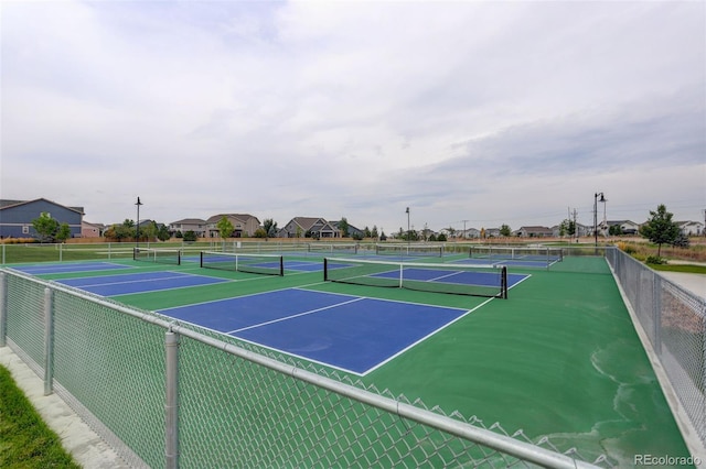 view of sport court featuring fence