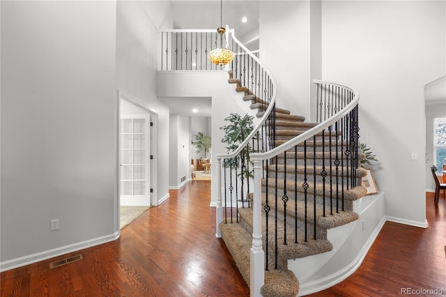 9453 Lark Sparrow Dr, Highlands Ranch, CO 80126 - staircase with wood finished floors, baseboards, and a high ceiling